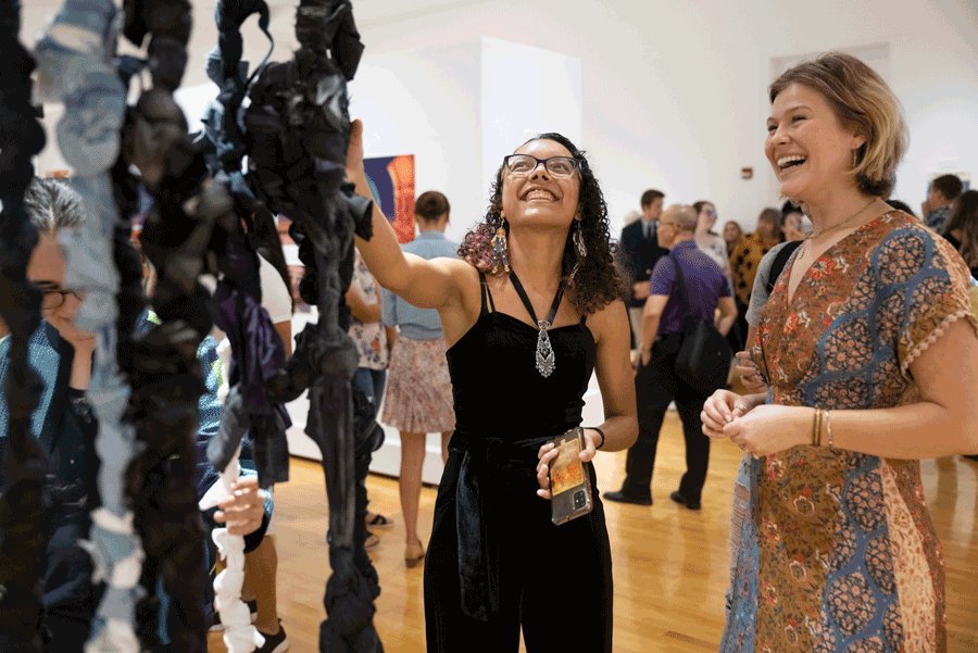Spring Senior Project, (left to right) Seniors Adrian Matheson and Sarah A. Baker speaking in front of Sarah A. Baker’s exhibition “Unraveling.” Photo by Darron Silva