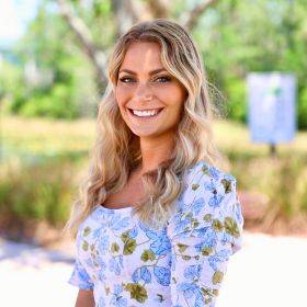 Maddie Richter, a smiling woman with blonde hair wearing a floral blouse