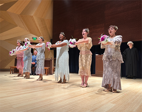 Opera image Women singing on stage with flowers
