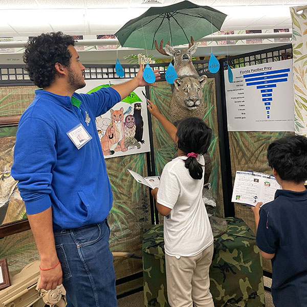 FGCU Student Assistant Franco helping students with scavenger hunt.