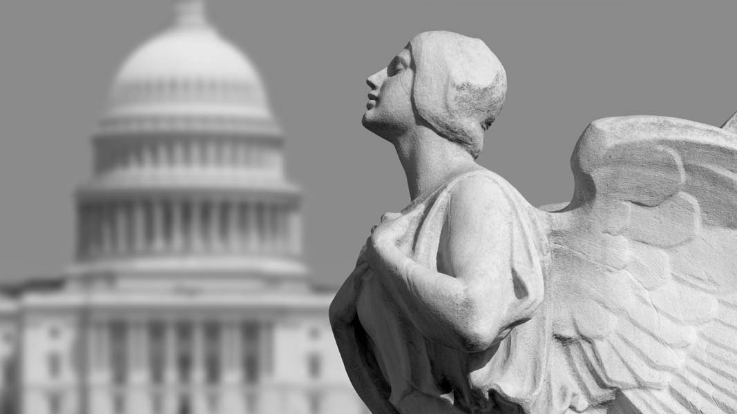 The winged figure of Democracy in front of the United States Capitol in Washington, DC