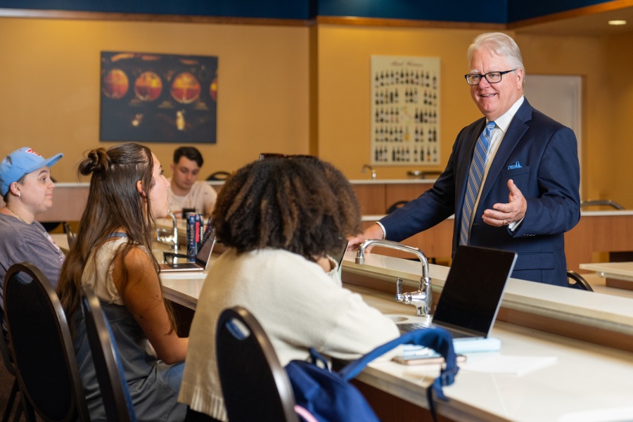 professor lecturing students in Wine Lab
