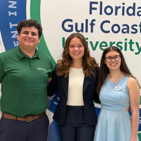 SRHM student group poses against an FGCU backdrop