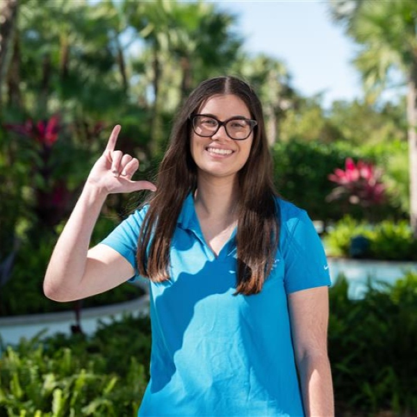student doing the "wings up" gesture with her hand