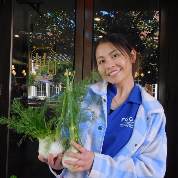 student with vegetable