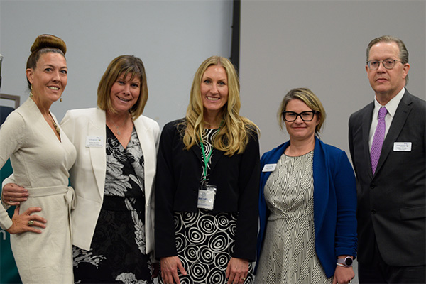 Keynote speaker joined by administrative staff members and faculty