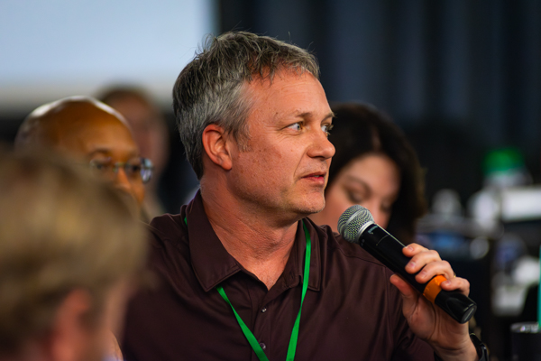 Attendee asking a question with a microphone