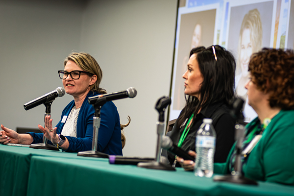 Three speakers on stage at the summit