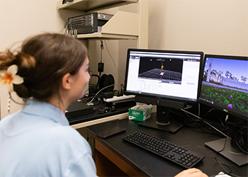 A student looks at a model of body movement on a computer.