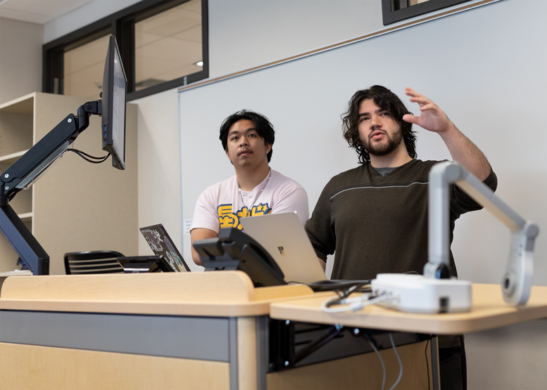 Two students present their programming project