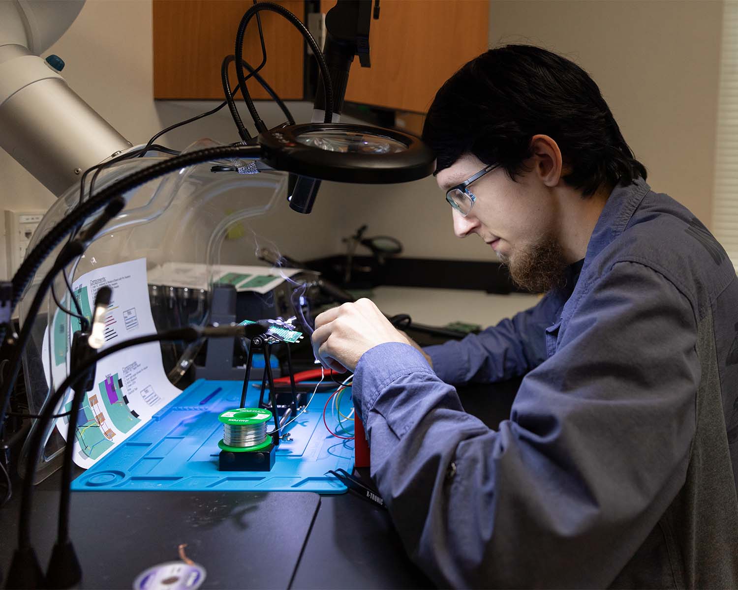 A software engineering student works on connecting circuits