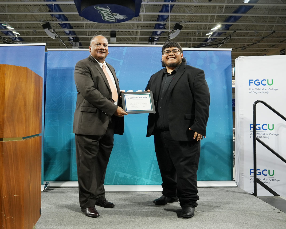 Alexis receives his award from Dr. Kagdi