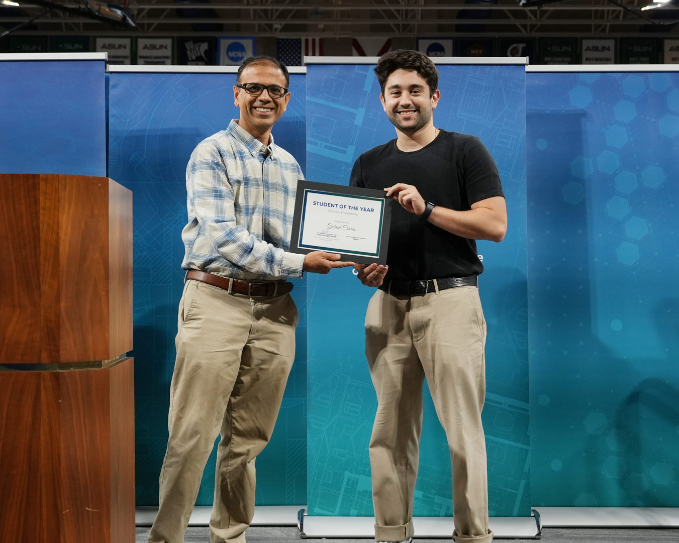 Gabriel receives his certificate from Dr. Ahuja