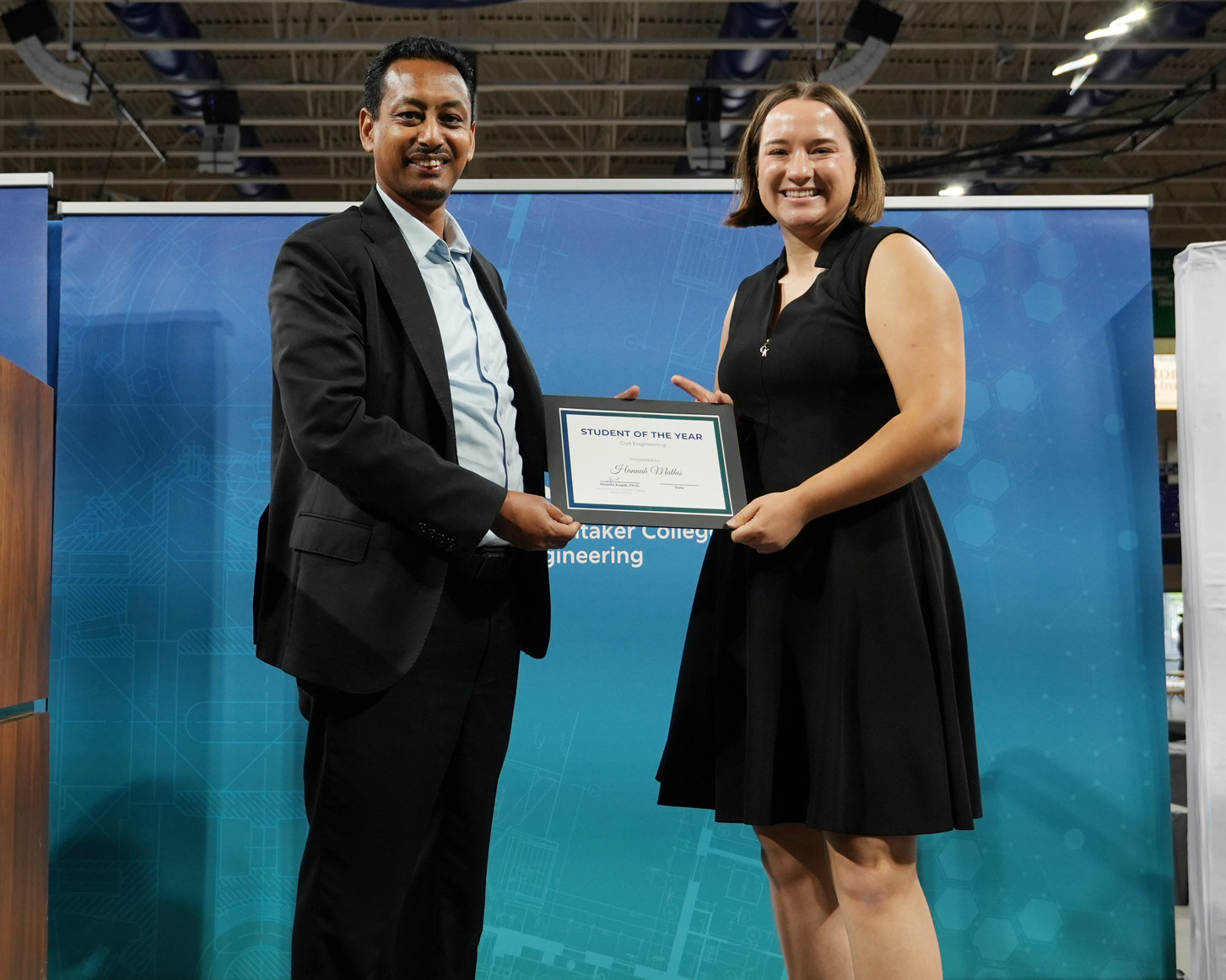 Hannah Mathis receives her certificate from Dr. Tsegaye