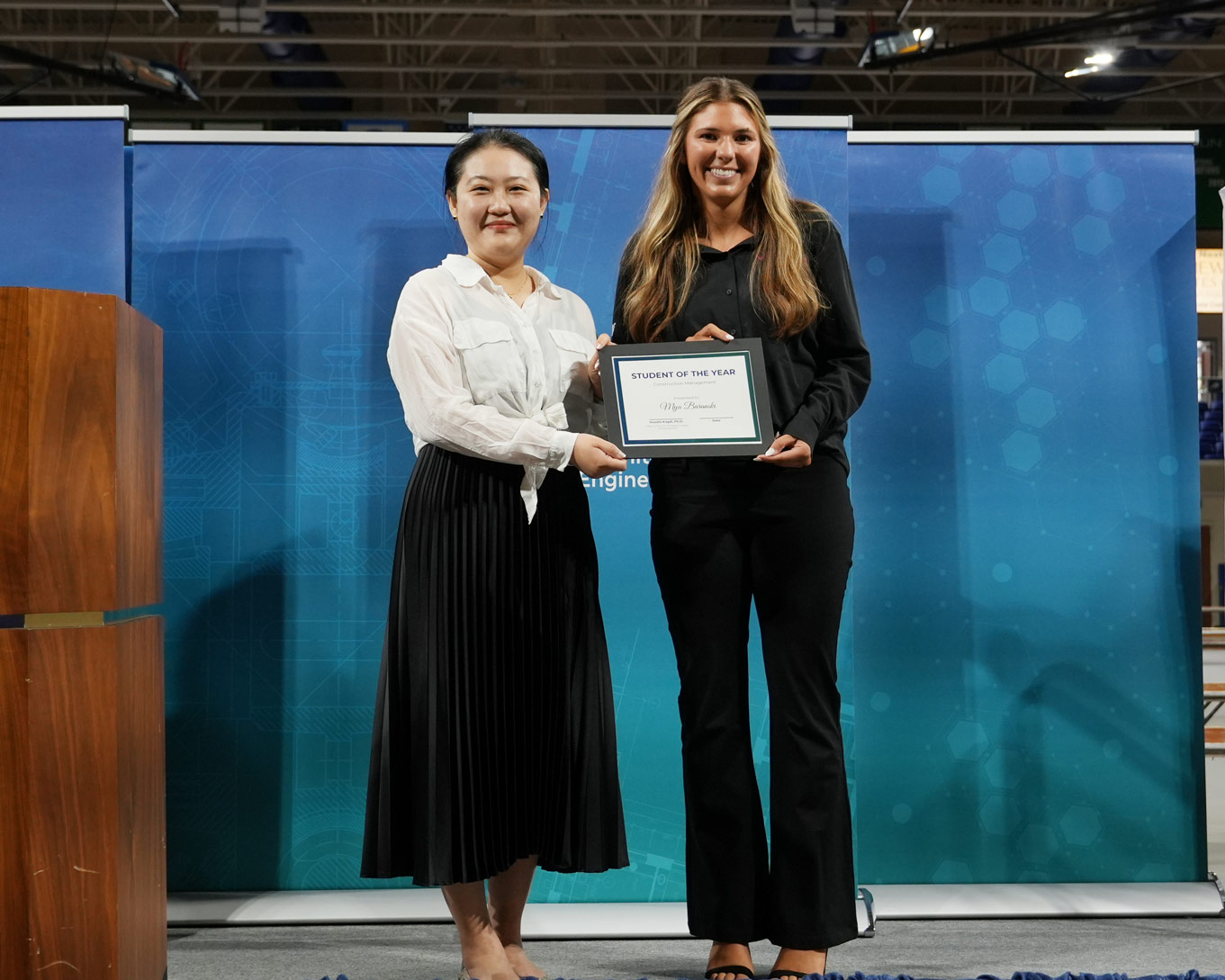 Mya receives her certificate from Dr. Bao