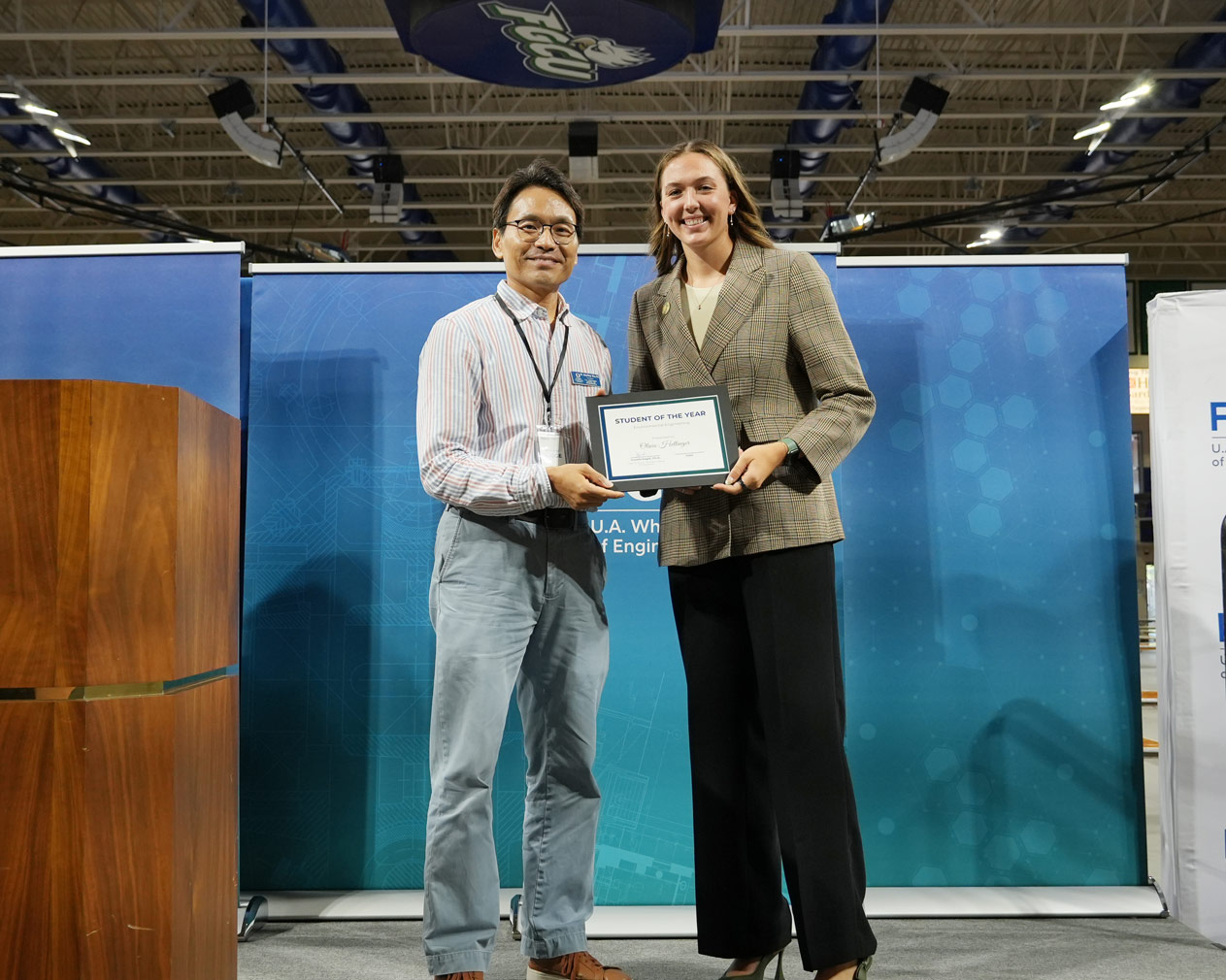 Olivia receives her certificate from Dr. Kim