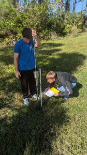Two researchers test soil