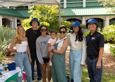 A group of students and faculty smile