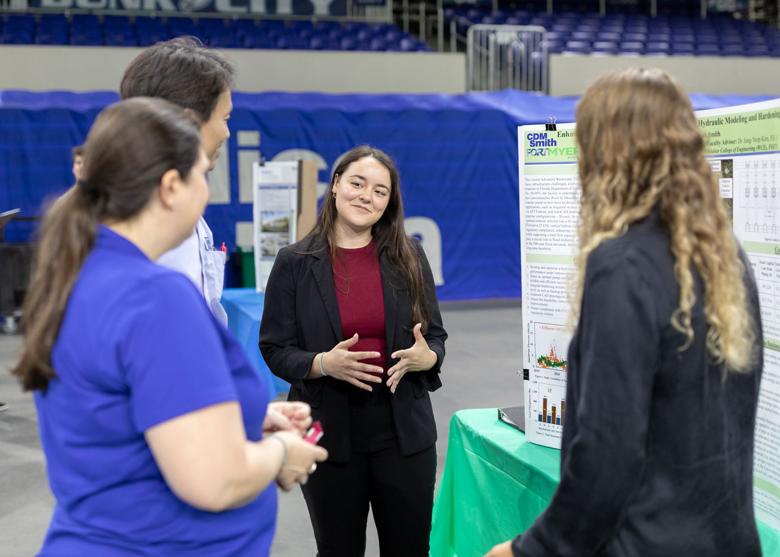 A student presents her senior project to a group