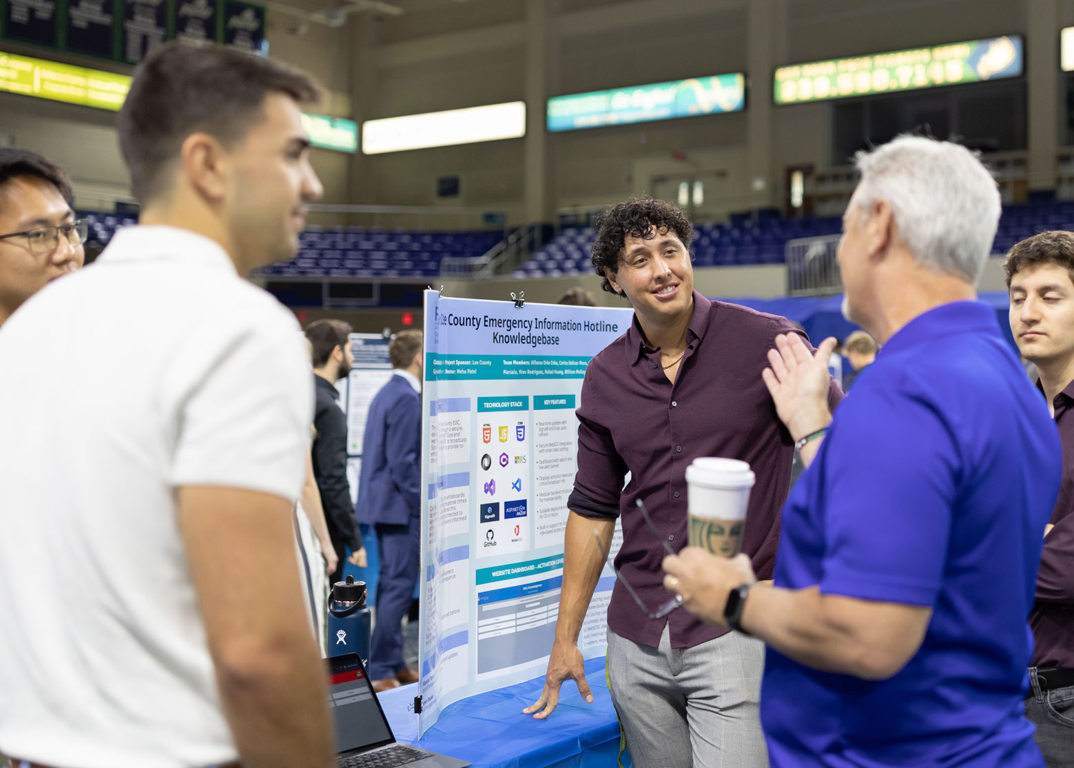 A student presents his capstone project to a group audience