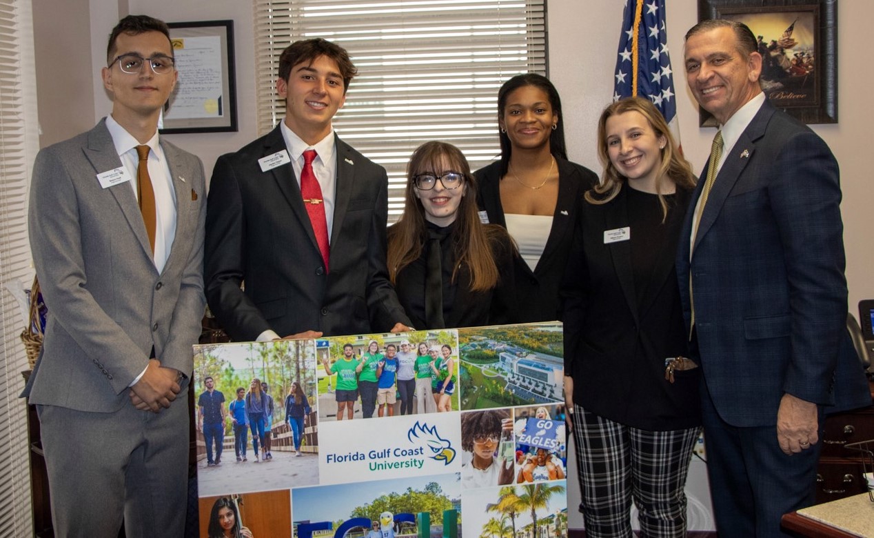 FGCU Day participants presenting Representative Rommel with an FGCU Photo Collage