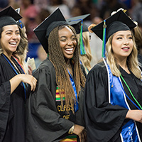 Three students in caps and gowns