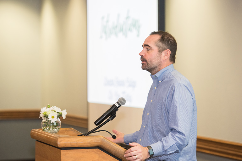 man speaking podium