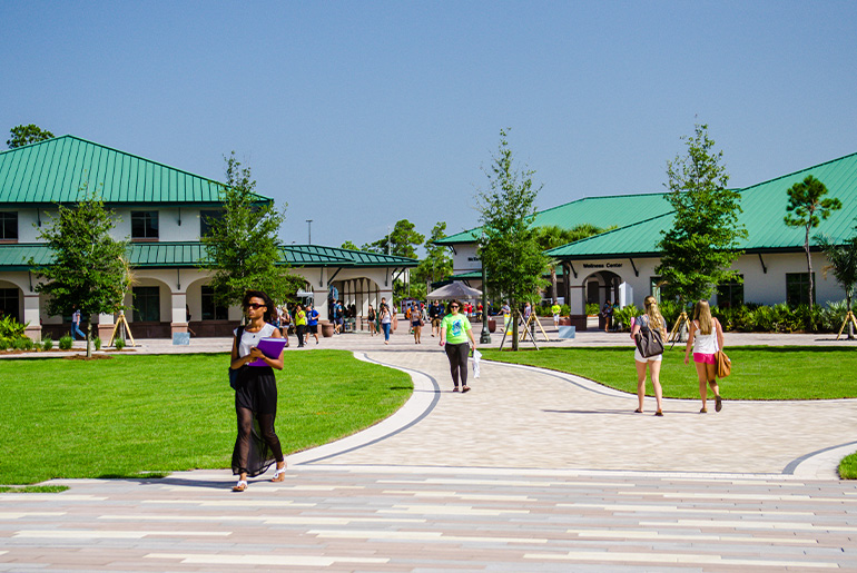 students walking campus building trees