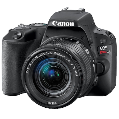 A black Canon EOS Rebel DSLR camera is pictured from the front, featuring an attached Canon EF-S 18-55mm zoom lens.