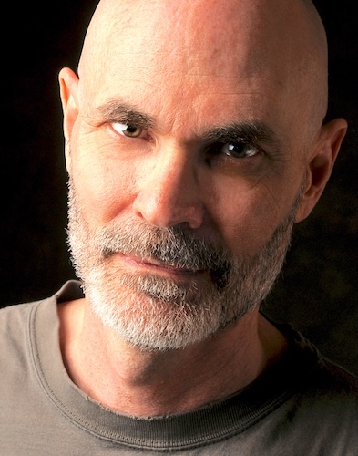 Headshot of James Brock. He is wearing a brown t-shirt.  