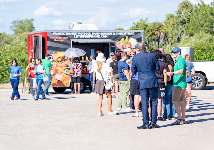 FGCU employees and their families are outside Swanson Stadum in line for food from a food truck.