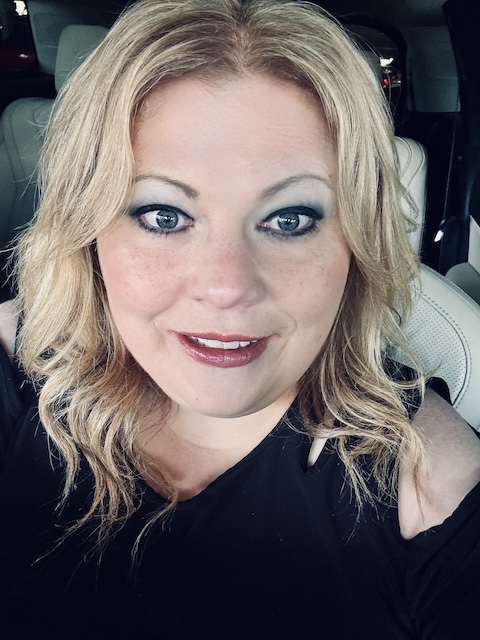 Headshot of Jennifer McGurk. Jennifer has short blond hair and is wearing a black blouse.