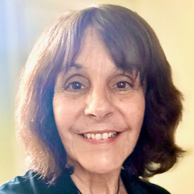 Headshot of Dr. Myra Mendible. She has short brown hair and is wearing a black blouse and cardigan. 