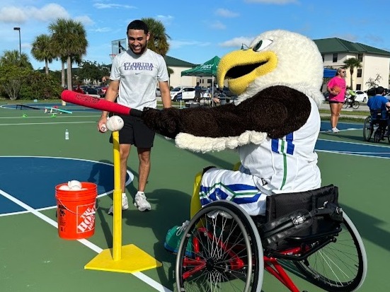 Azul-school mascot in wheelchair playing adaptive baseball