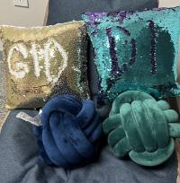 Image of sequence pillows spelling GIDDI and knotted pillows