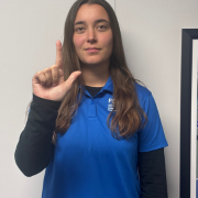 Image of FGCU GIDDI employee signing L Point your index finger up and your thumb straight out to the side, forming an "L" shape.
