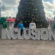 FGCU employees at Race for Inclusion standing with a light up sign stating "inclusion"