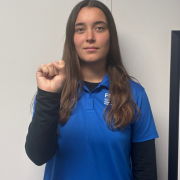 Image of FGCU GIDDI employee signing S Make a tight fist, and wrap your thumb over the front of your fingers (like a standard boxing fist).