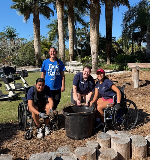 OT Students planting with adaptive gardening