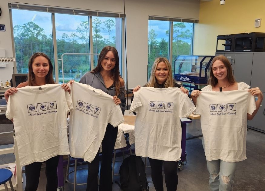 Girls holding shirts