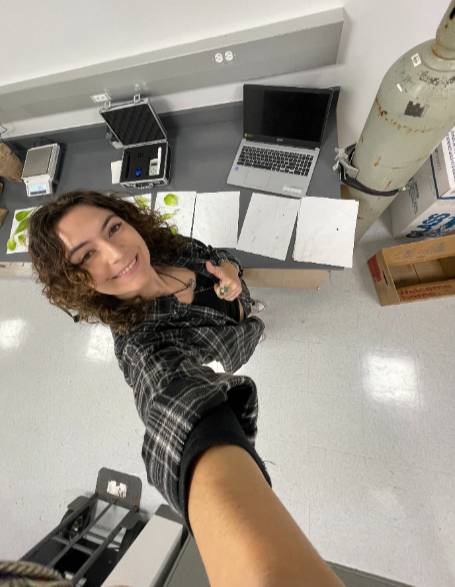 student taking selfie by laptop