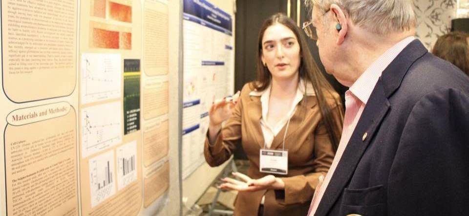 Student presenting research poster