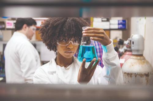 Photo of a student with a beaker Photo of a student with a beaker