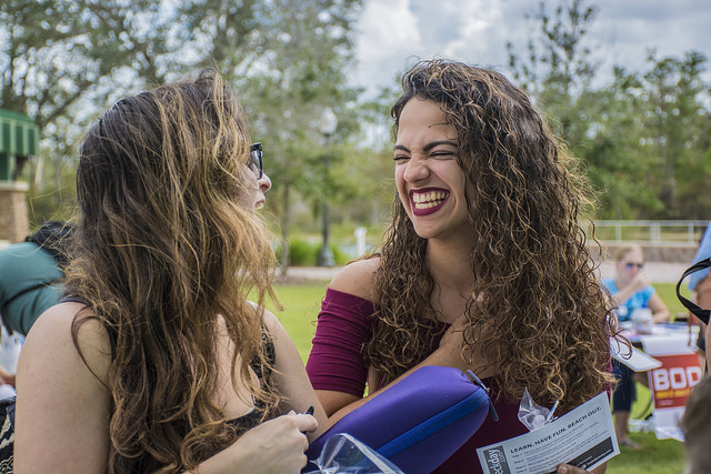 friends smiling with books in hand