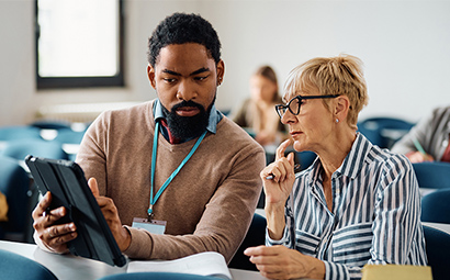 Elderly lady learning from young man